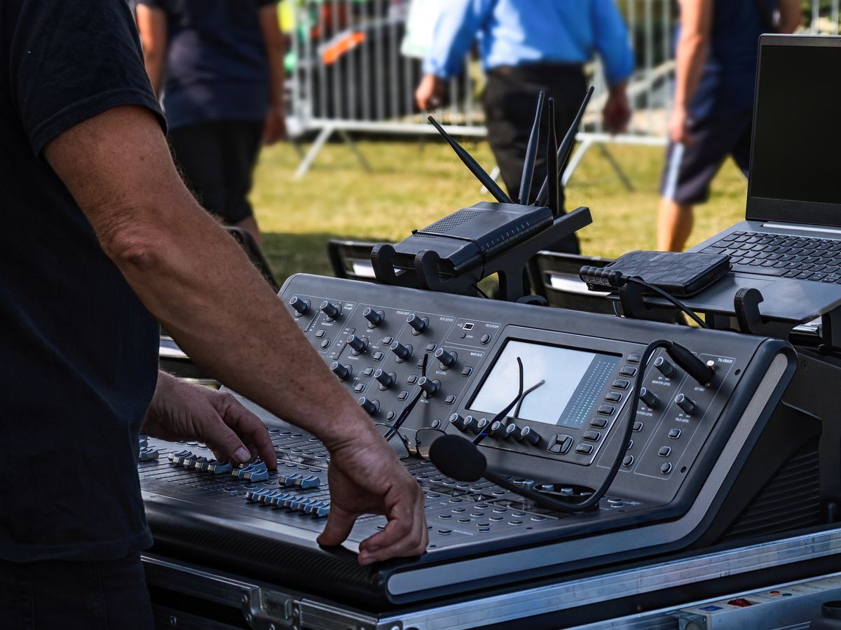 Audio engineer operating a mixing console at a live event