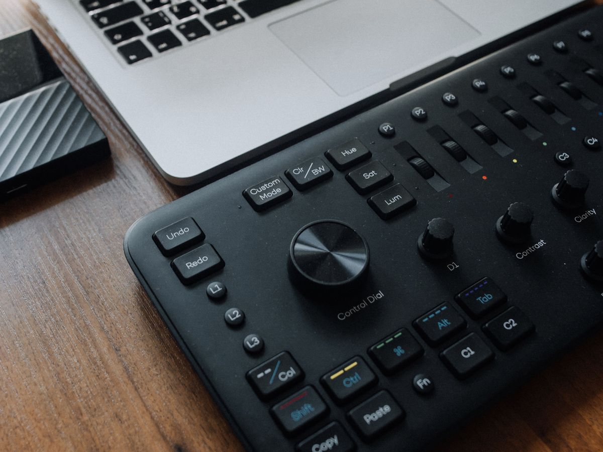 Editing console and laptop set up for demanding creative work