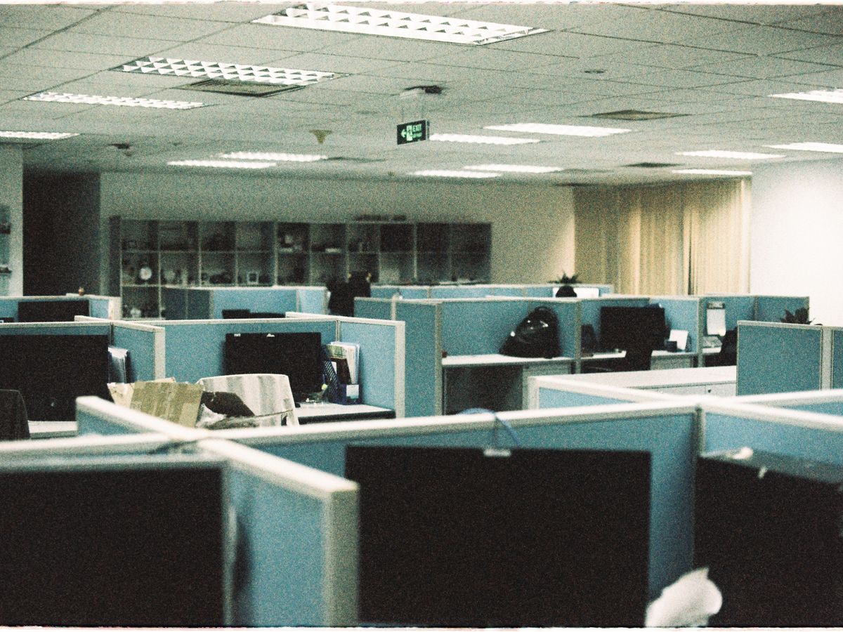 Rows of desks and monitors across an office floor