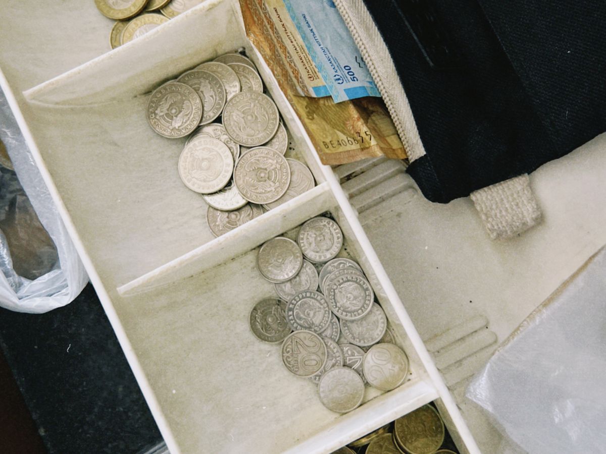 Cash drawer with notes and coins at the counter