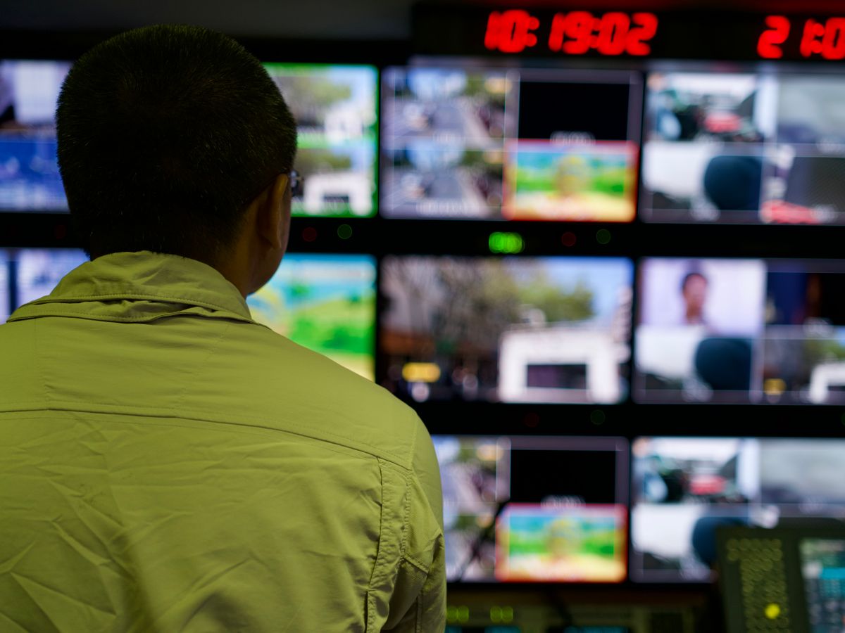 Operator reviewing multiple surveillance monitors
