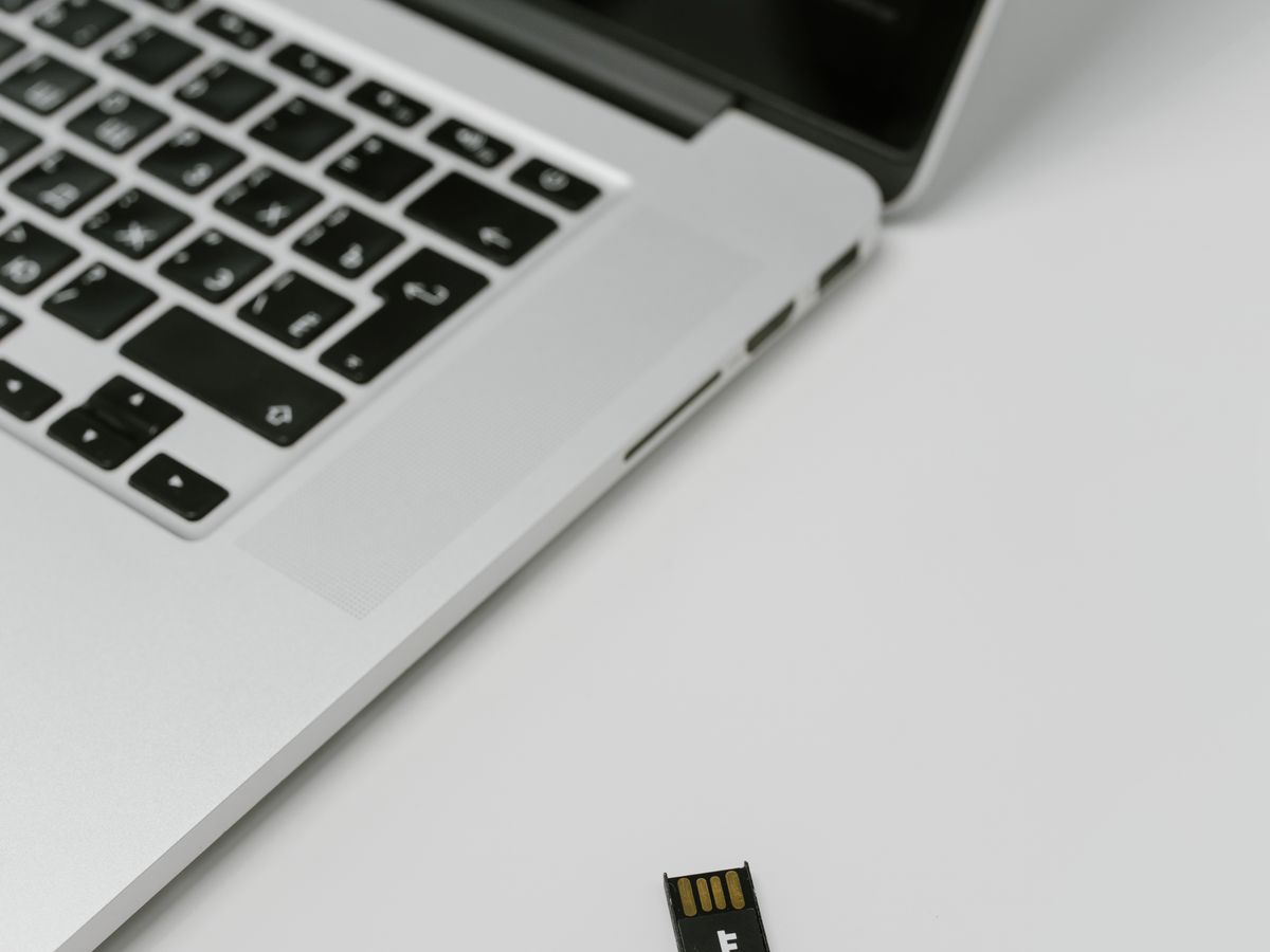 Hardware security key beside a laptop for two-factor authentication